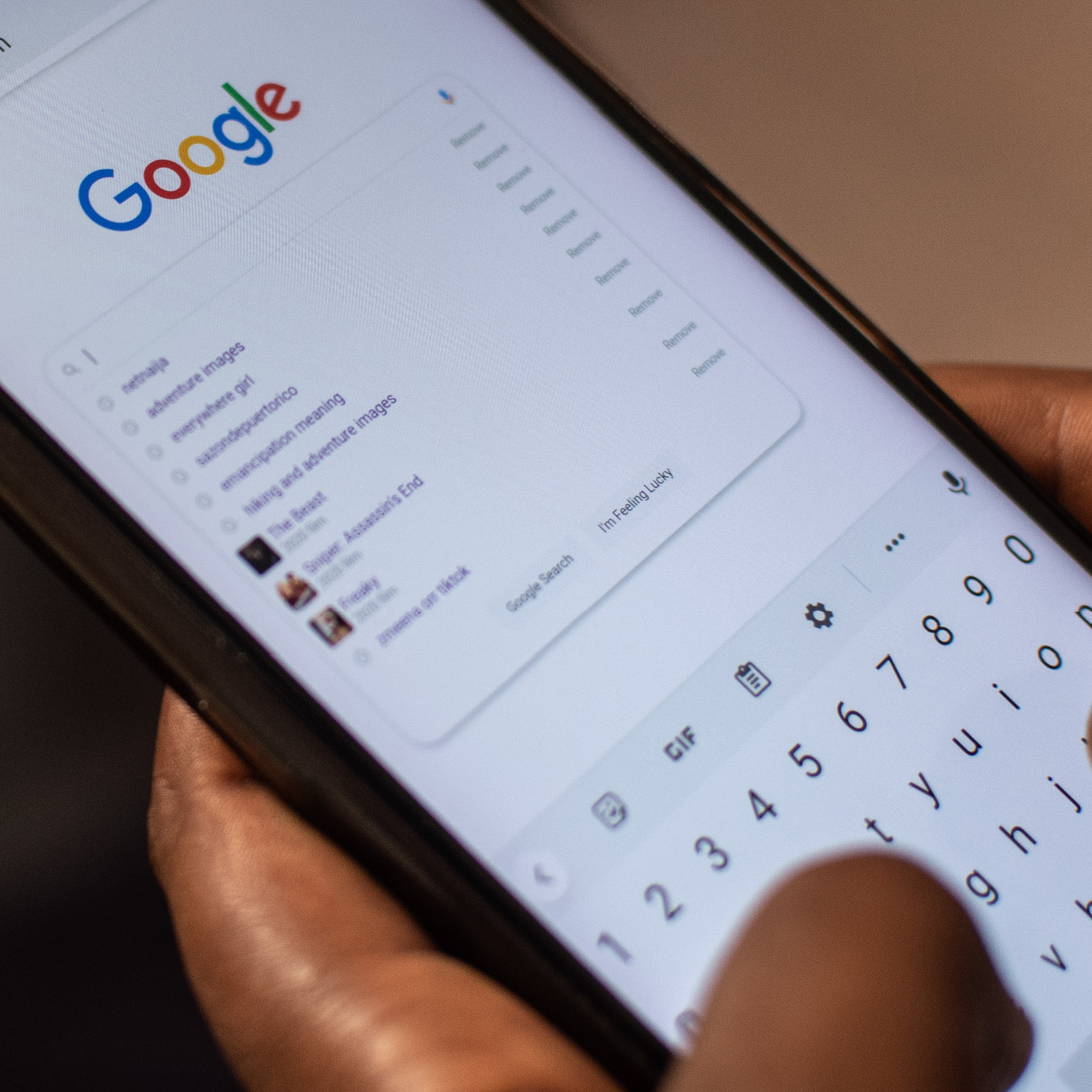 Person performing a Google Search on Phone